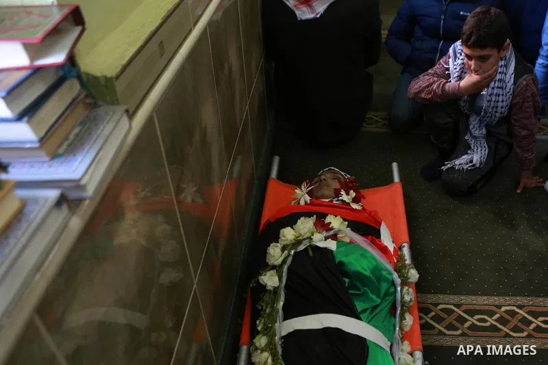 Relatives of Mohammad Zeidan, 16, a Palestinian youth who was killed by Israeli security forces on Nov. 25 after allegedly attempting to carry out a stabbing attack mourn during his funeral in the West Bank village of Bi...