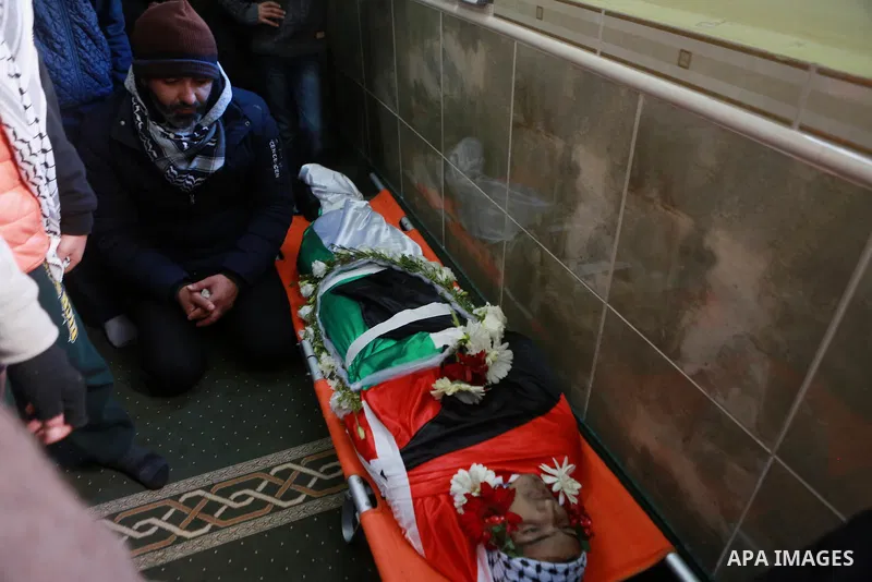 Relatives of Mohammad Zeidan, 16, a Palestinian youth who was killed by Israeli security forces on Nov. 25 after allegedly attempting to carry out a stabbing attack mourn during his funeral in the West Bank village of Bi...
