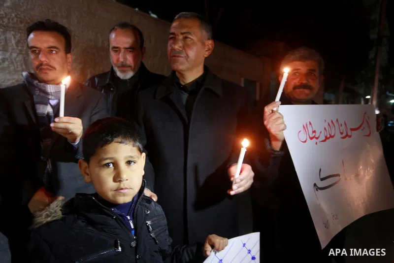 Palestinians hold placards and light candles during a protest to show solidarity with Palestinian prisoners held in Israeli Jails, in front of Red cross office in Gaza city, on February 2, 2017. Photo by Mohammed Asad