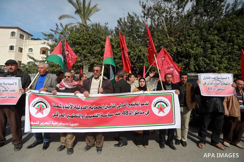 Palestinians hold placards during a protest to show solidarity with Palestinian prisoners held in Israeli Jails, in Gaza city, on February 4, 2017. Photo by Mohammed Asad