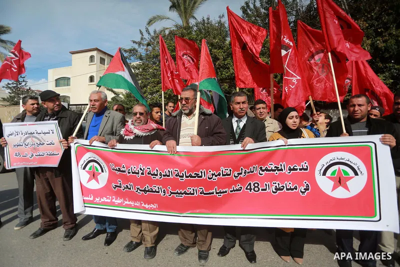 Palestinians hold placards during a protest to show solidarity with Palestinian prisoners held in Israeli Jails, in Gaza city, on February 4, 2017. Photo by Mohammed Asad