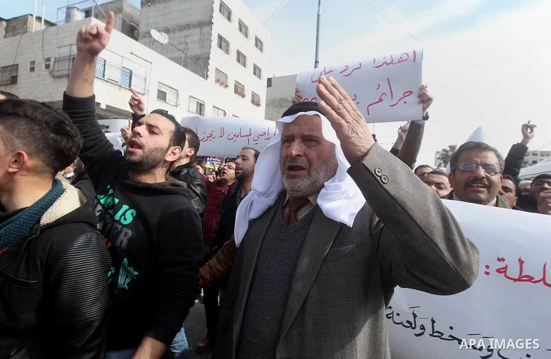 Palestinian protesters take part in a demonstration organised by Hizb el-Tahrir against what they say is a decision by Palestinian Authority granting an Islamic land to a Russian church in the West Bank city of Hebron Fe...