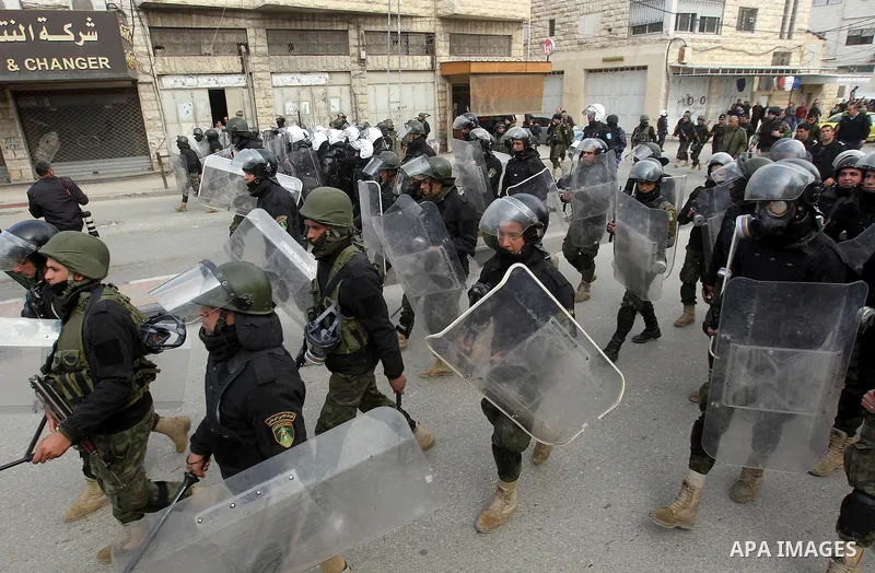 Palestinian policemen arrive to disperse demonstrators during a protest against a decision by the Palestinian Authority to grant a public land to the Russian church, in the West Bank city of Hebron, on February 4, 2017....