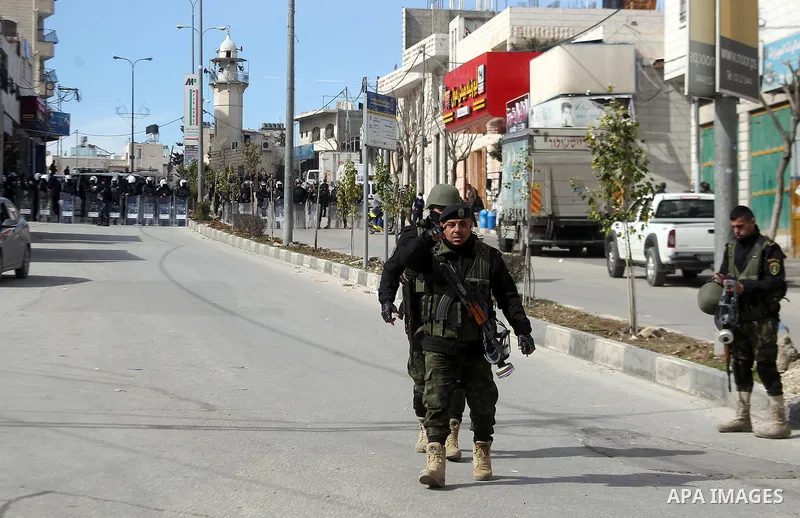 Palestinian policemen arrive to disperse demonstrators during a protest against a decision by the Palestinian Authority to grant a public land to the Russian church, in the West Bank city of Hebron, on February 4, 2017....