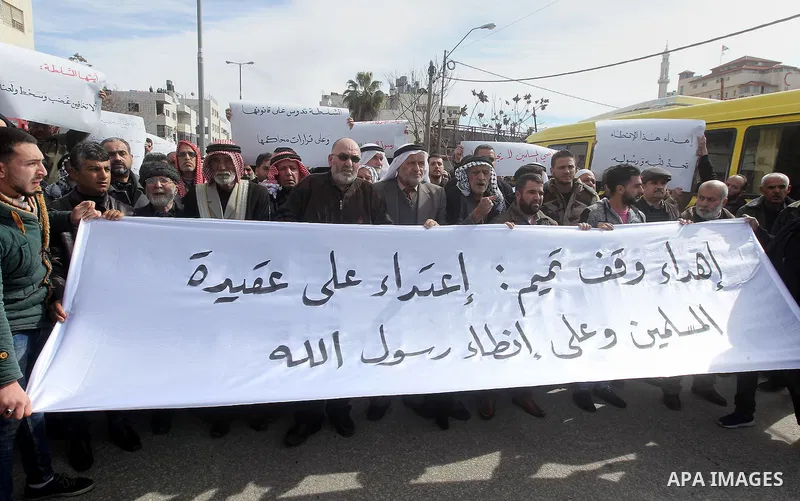 Palestinian protesters take part in a demonstration organised by Hizb el-Tahrir against what they say is a decision by Palestinian Authority granting an Islamic land to a Russian church in the West Bank city of Hebron Fe...