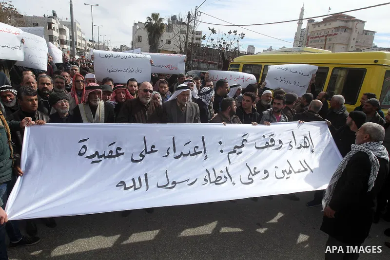 Palestinian protesters take part in a demonstration organised by Hizb el-Tahrir against what they say is a decision by Palestinian Authority granting an Islamic land to a Russian church in the West Bank city of Hebron Fe...