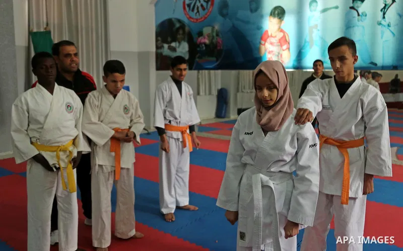 A Palestinian blind girl, Menna Allah al Bitar, takes part in a Karate class at the club Mashtal in Gaza city on February 5, 2017. The training is held twice a week by the club to lift the morale of the children, trainer...