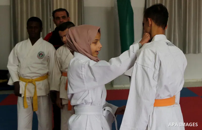 A Palestinian blind girl, Menna Allah al Bitar, takes part in a Karate class at the club Mashtal in Gaza city on February 5, 2017. The training is held twice a week by the club to lift the morale of the children, trainer...