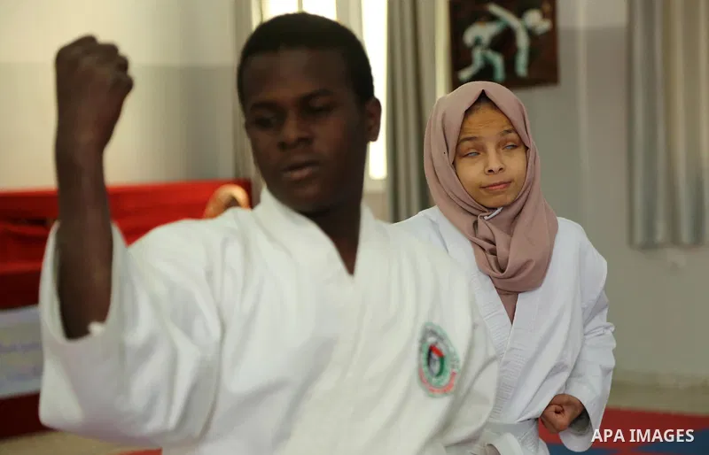 A Palestinian blind girl, Menna Allah al Bitar, takes part in a Karate class at the club Mashtal in Gaza city on February 5, 2017. The training is held twice a week by the club to lift the morale of the children, trainer...