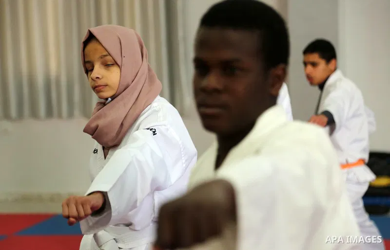 A Palestinian blind girl, Menna Allah al Bitar, takes part in a Karate class at the club Mashtal in Gaza city on February 5, 2017. The training is held twice a week by the club to lift the morale of the children, trainer...