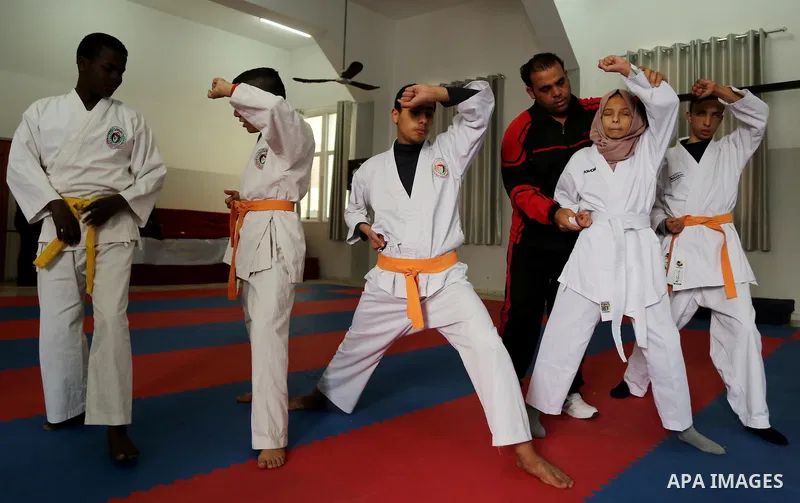 A Palestinian blind girl, Menna Allah al Bitar, takes part in a Karate class at the club Mashtal in Gaza city on February 5, 2017. The training is held twice a week by the club to lift the morale of the children, trainer...