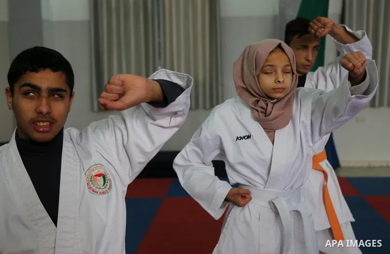 A Palestinian blind girl, Menna Allah al Bitar, takes part in a Karate class at the club Mashtal in Gaza city on February 5, 2017. The training is held twice a week by the club to lift the morale of the children, trainer...