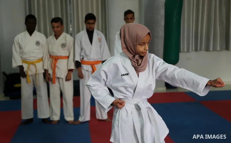 A Palestinian blind girl, Menna Allah al Bitar, takes part in a Karate class at the club Mashtal in Gaza city on February 5, 2017. The training is held twice a week by the club to lift the morale of the children, trainer...
