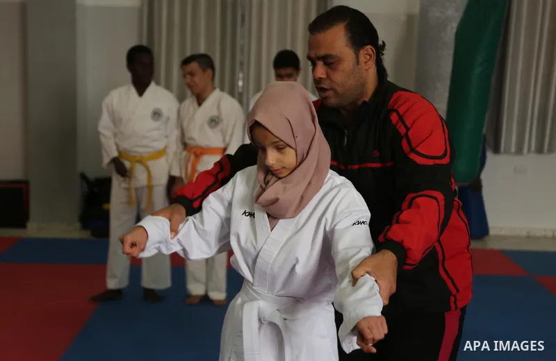 A Palestinian blind girl, Menna Allah al Bitar, takes part in a Karate class at the club Mashtal in Gaza city on February 5, 2017. The training is held twice a week by the club to lift the morale of the children, trainer...