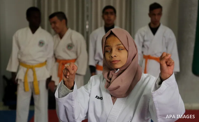 A Palestinian blind girl, Menna Allah al Bitar, takes part in a Karate class at the club Mashtal in Gaza city on February 5, 2017. The training is held twice a week by the club to lift the morale of the children, trainer...