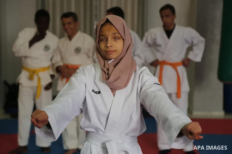 A Palestinian blind girl, Menna Allah al Bitar, takes part in a Karate class at the club Mashtal in Gaza city on February 5, 2017. The training is held twice a week by the club to lift the morale of the children, trainer...
