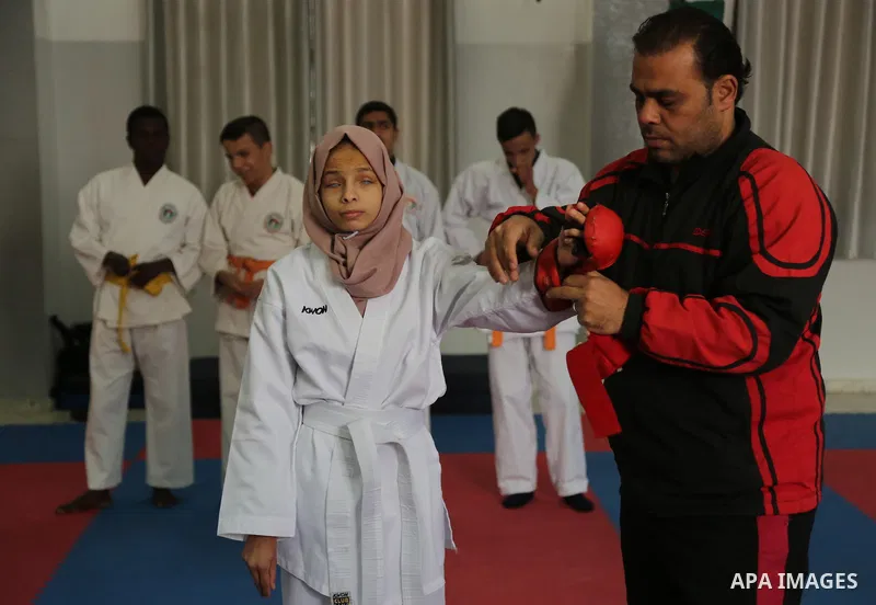 A Palestinian blind girl, Menna Allah al Bitar, takes part in a Karate class at the club Mashtal in Gaza city on February 5, 2017. The training is held twice a week by the club to lift the morale of the children, trainer...