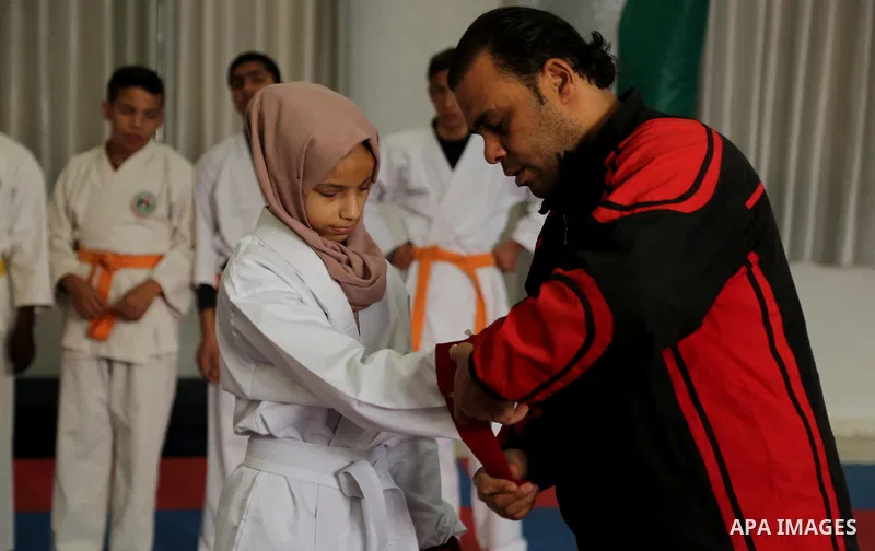 A Palestinian blind girl, Menna Allah al Bitar, takes part in a Karate class at the club Mashtal in Gaza city on February 5, 2017. The training is held twice a week by the club to lift the morale of the children, trainer...