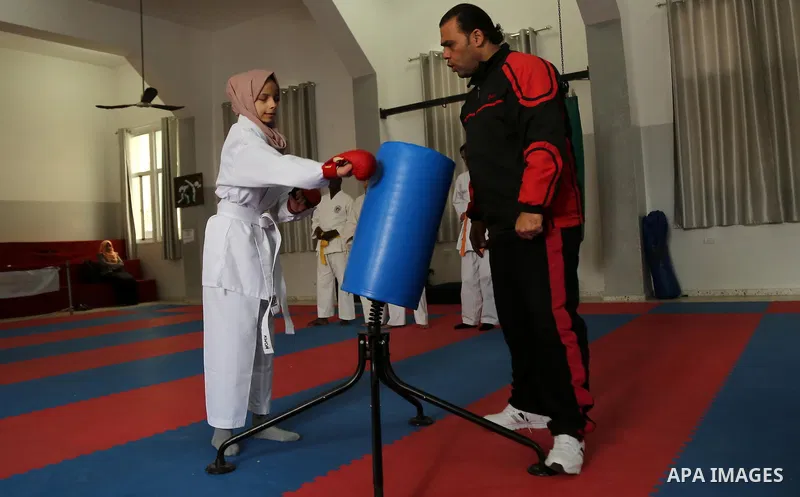A Palestinian blind girl, Menna Allah al Bitar, takes part in a Karate class at the club Mashtal in Gaza city on February 5, 2017. The training is held twice a week by the club to lift the morale of the children, trainer...