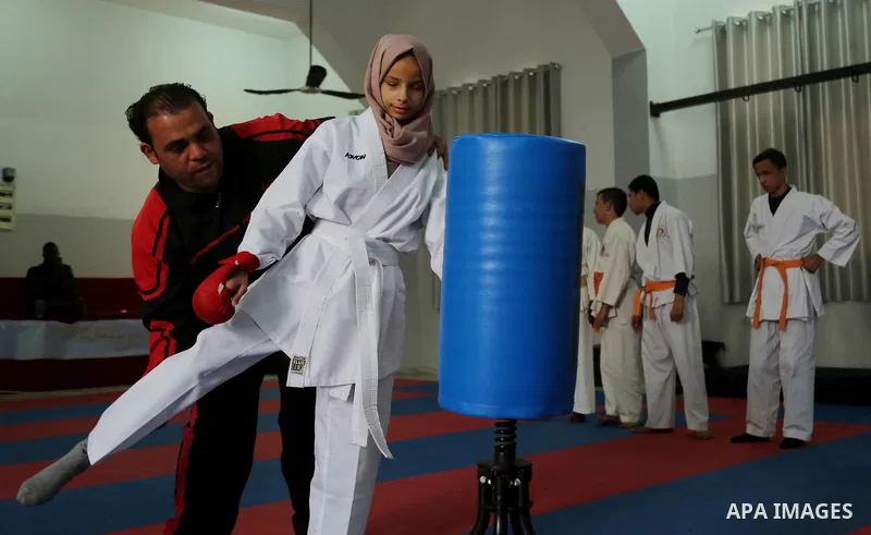 A Palestinian blind girl, Menna Allah al Bitar, takes part in a Karate class at the club Mashtal in Gaza city on February 5, 2017. The training is held twice a week by the club to lift the morale of the children, trainer...