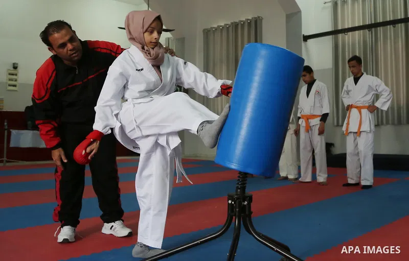 A Palestinian blind girl, Menna Allah al Bitar, takes part in a Karate class at the club Mashtal in Gaza city on February 5, 2017. The training is held twice a week by the club to lift the morale of the children, trainer...