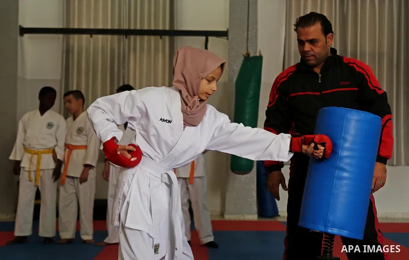 A Palestinian blind girl, Menna Allah al Bitar, takes part in a Karate class at the club Mashtal in Gaza city on February 5, 2017. The training is held twice a week by the club to lift the morale of the children, trainer...