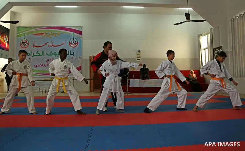 A Palestinian blind girl, Menna Allah al Bitar, takes part in a Karate class at the club Mashtal in Gaza city on February 5, 2017. The training is held twice a week by the club to lift the morale of the children, trainer...