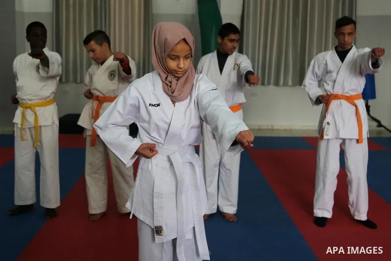A Palestinian blind girl, Menna Allah al Bitar, takes part in a Karate class at the club Mashtal in Gaza city on February 5, 2017. The training is held twice a week by the club to lift the morale of the children, trainer...