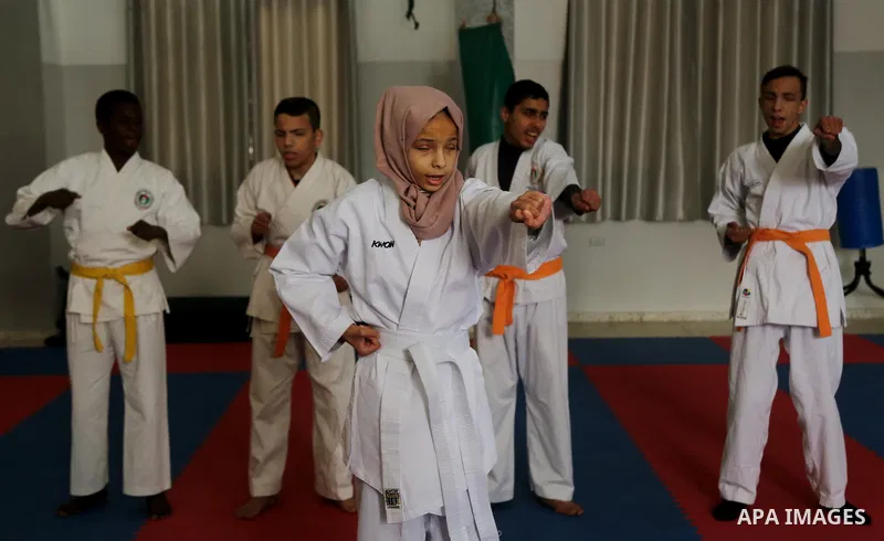 A Palestinian blind girl, Menna Allah al Bitar, takes part in a Karate class at the club Mashtal in Gaza city on February 5, 2017. The training is held twice a week by the club to lift the morale of the children, trainer...