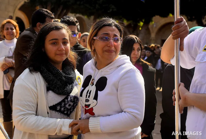 Egyptian Christians mourn during the funeral of Demiana Amir, 14, who was died last night after she was wounded at a bomb explosion that targeted the Saint Peter and Saint Paul Coptic Orthodox Church in December 2016 in...