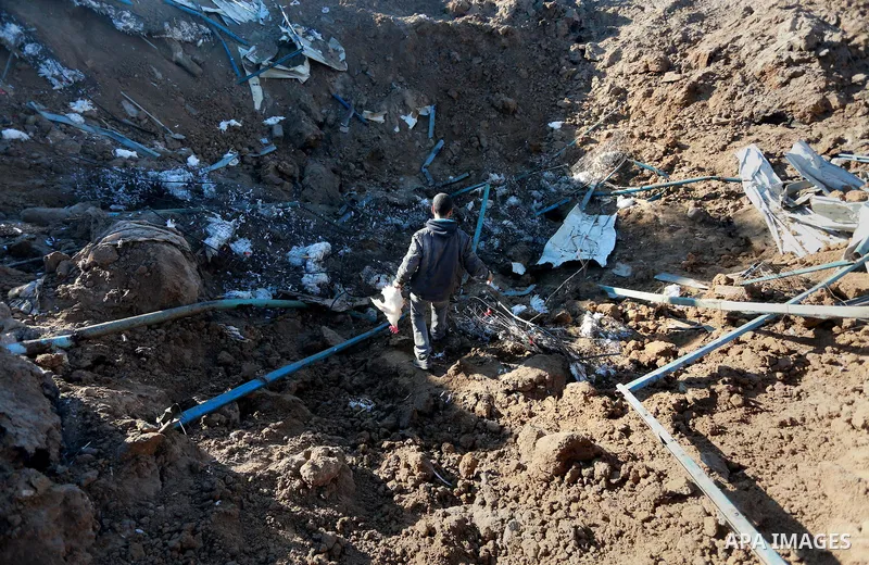 Palestinians inspect the damage to a chicken farm in Gaza City's eastern suburb of Shujaiya on February 7, 2017, following a series of strikes carried out the day before by Israeli forces against the Hamas movement in th...