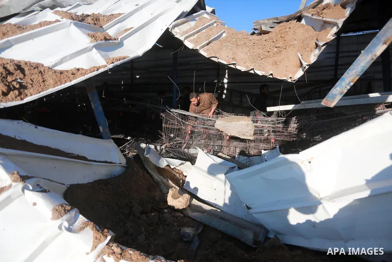 Palestinians inspect the damage to a chicken farm in Gaza City's eastern suburb of Shujaiya on February 7, 2017, following a series of strikes carried out the day before by Israeli forces against the Hamas movement in th...