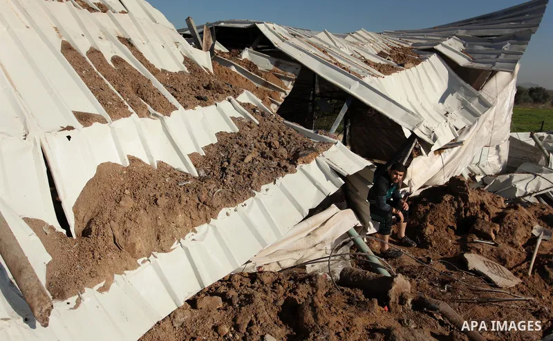 Palestinians inspect the damage to a chicken farm in Gaza City's eastern suburb of Shujaiya on February 7, 2017, following a series of strikes carried out the day before by Israeli forces against the Hamas movement in th...
