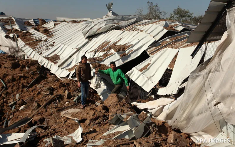 Palestinians inspect the damage to a chicken farm in Gaza City's eastern suburb of Shujaiya on February 7, 2017, following a series of strikes carried out the day before by Israeli forces against the Hamas movement in th...