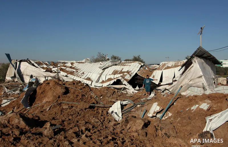 Palestinians inspect the damage to a chicken farm in Gaza City's eastern suburb of Shujaiya on February 7, 2017, following a series of strikes carried out the day before by Israeli forces against the Hamas movement in th...