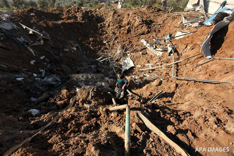 Palestinians inspect the damage to a chicken farm in Gaza City's eastern suburb of Shujaiya on February 7, 2017, following a series of strikes carried out the day before by Israeli forces against the Hamas movement in th...