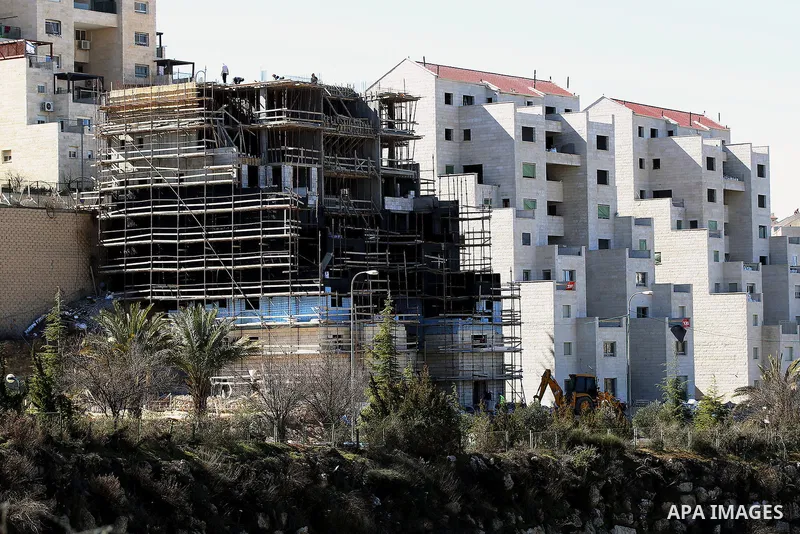 A picture taken from the West Bank city of Hebron on February 7, 2017 shows a view of the Kiryat Arba Jewish settlement on the outskirts of the Palestinian city. Israel’s parliament passed a contentious law late Monday t...
