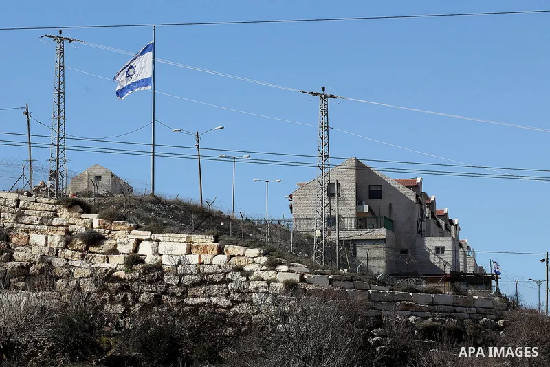A picture taken from the West Bank city of Hebron on February 7, 2017 shows a view of the Kiryat Arba Jewish settlement on the outskirts of the Palestinian city. Israel’s parliament passed a contentious law late Monday t...