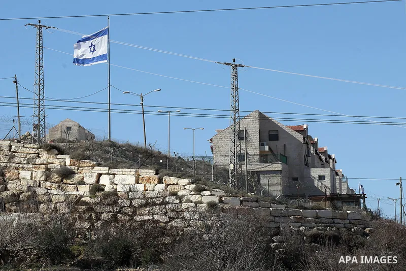 A picture taken from the West Bank city of Hebron on February 7, 2017 shows a view of the Kiryat Arba Jewish settlement on the outskirts of the Palestinian city. Israel’s parliament passed a contentious law late Monday t...