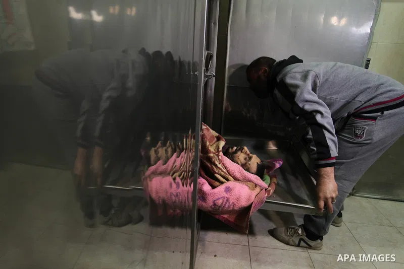 A Relative of one of the two Palestinians, who were killed in a bombing of a tunnel near the Egyptian border, mourn over his body at a morgue in hospital in Rafah in the southern Gaza Strip February 9, 2017. Photo by Ash...