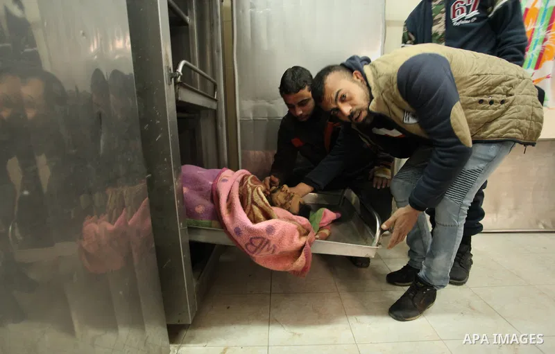 Relatives of the two Palestinians, who were killed in a bombing of a tunnel near the Egyptian border, mourn over their body at a morgue in hospital in Rafah in the southern Gaza Strip February 9, 2017. Photo by Ashraf Am...
