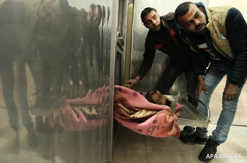 A Relative of one of the two Palestinians, who were killed in a bombing of a tunnel near the Egyptian border, mourn over his body at a morgue in hospital in Rafah in the southern Gaza Strip February 9, 2017. Photo by Ash...