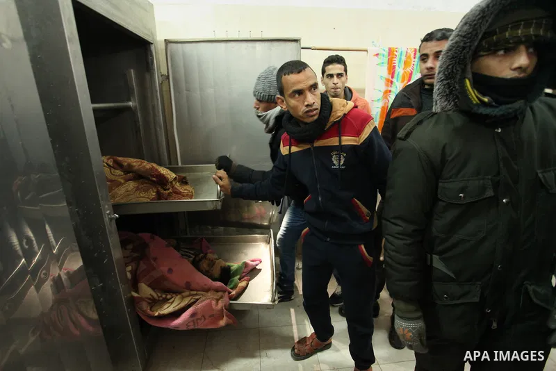 Relatives of the two Palestinians, who were killed in a bombing of a tunnel near the Egyptian border, mourn over their body at a morgue in hospital in Rafah in the southern Gaza Strip February 9, 2017. Photo by Ashraf Am...