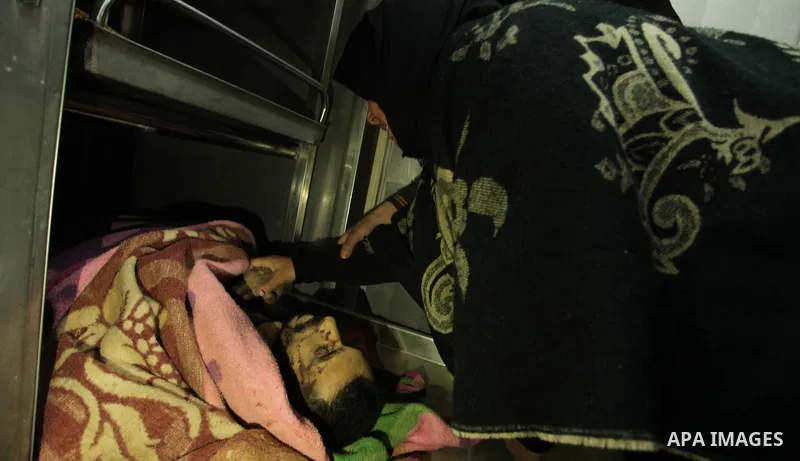 The sister of one of the two Palestinians, who were killed in a bombing of a tunnel near the Egyptian border, mourns over his body at a hospital in Rafah in the southern Gaza Strip February 9, 2017. Photo by Ashraf Amra