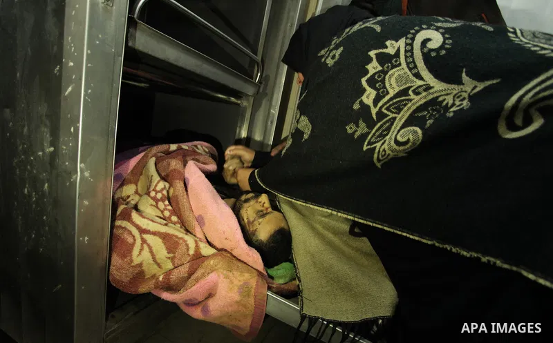 The sister of one of the two Palestinians, who were killed in a bombing of a tunnel near the Egyptian border, mourns over his body at a hospital in Rafah in the southern Gaza Strip February 9, 2017. Photo by Ashraf Amra
