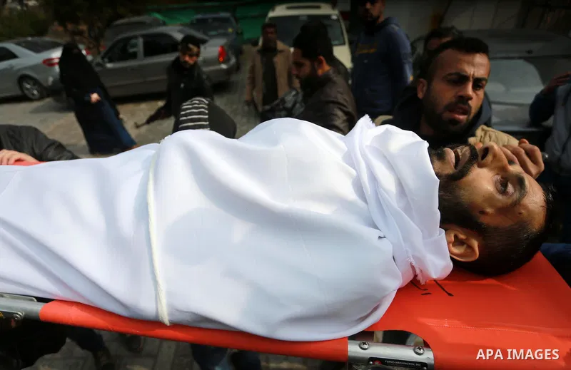 Mourners carry the body of Palestinian Mohammed al-Aqraa, who was killed in a tunnel explosion near the Egyptian border, during his funeral in Gaza City February 9, 2017. Photo by Mohammed Asad