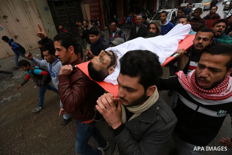 Mourners carry the body of Palestinian Mohammed al-Aqraa, who was killed in a tunnel explosion near the Egyptian border, during his funeral in Gaza City February 9, 2017. Photo by Mohammed Asad