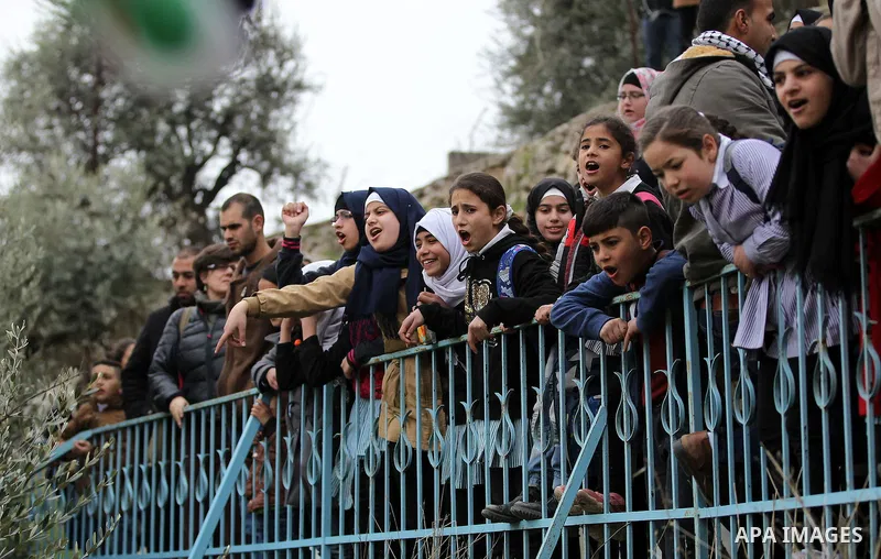 Palestinian schoolchildren take part in a protest calling for reopening of a closed street, in the West Bank city of Hebron February 9, 2017. Photo by Wisam Hashlamoun