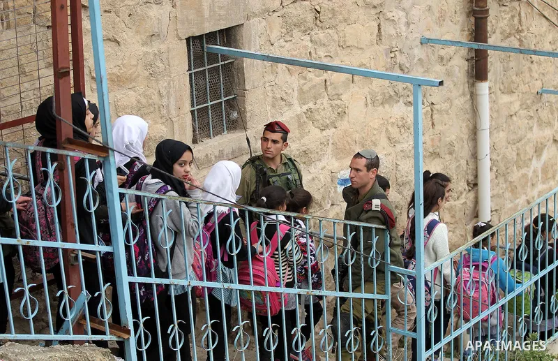 Palestinian schoolchildren take part in a protest calling for reopening of a closed street, in the West Bank city of Hebron February 9, 2017. Photo by Wisam Hashlamoun
