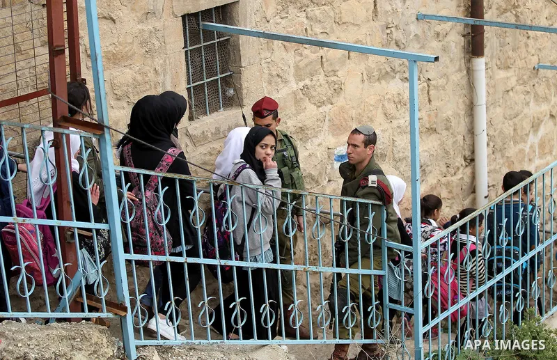 Palestinian schoolchildren take part in a protest calling for reopening of a closed street, in the West Bank city of Hebron February 9, 2017. Photo by Wisam Hashlamoun